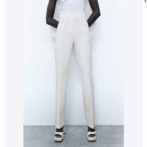 White pleated waist and slight flared dress slacks